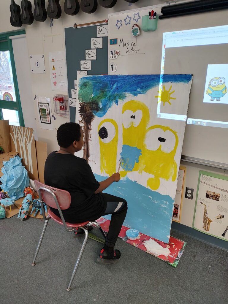 Student working on a large scale painting.