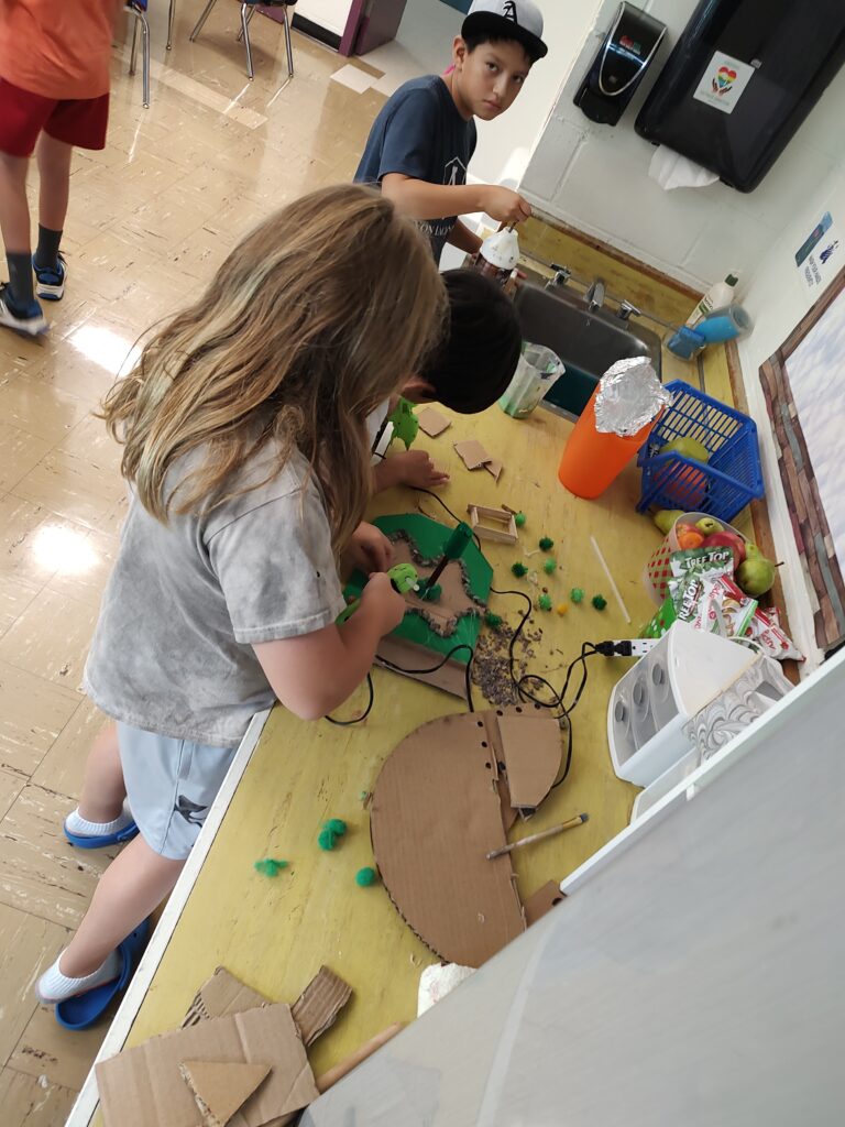 Students working to construct a model of the SA grounds.