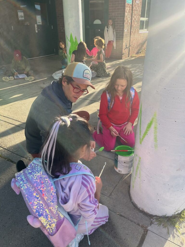 Students help repaint the school pillars