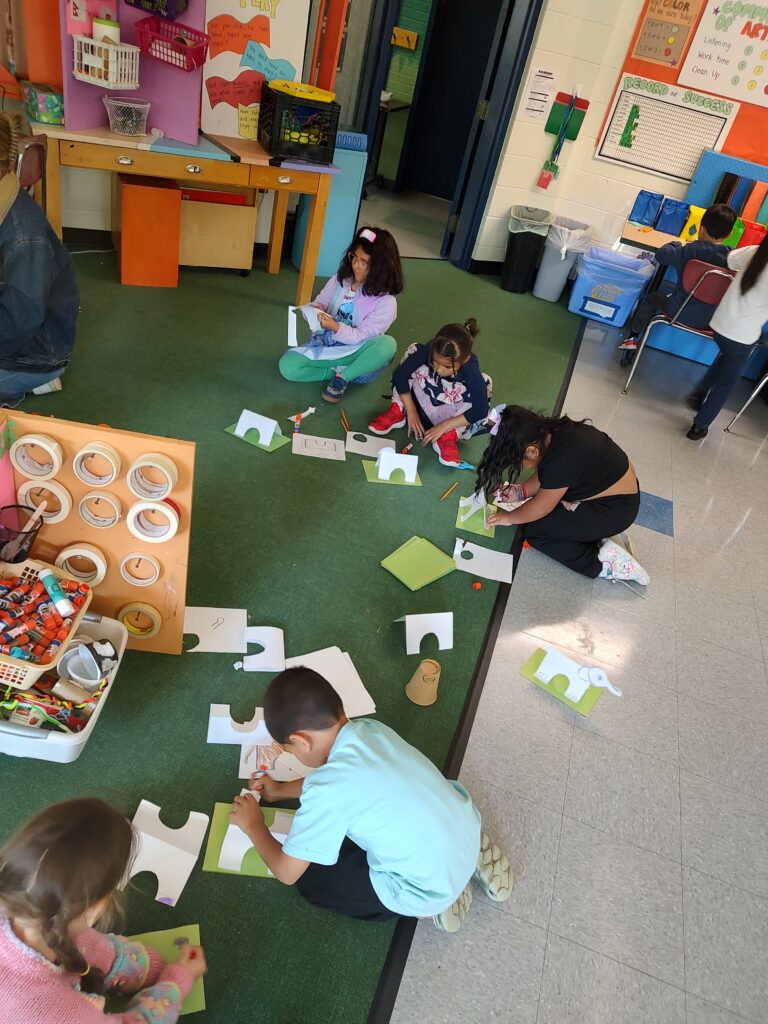 1st graders engineering sculptures with simple shapes.