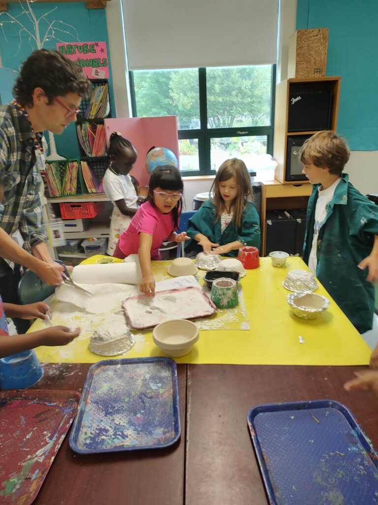 Students gather around to work with plaster.